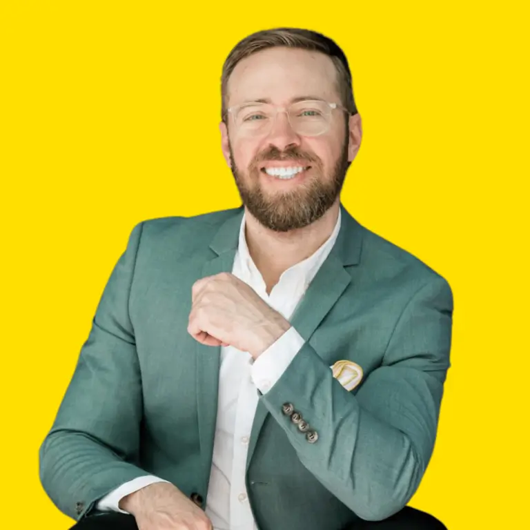 Nick Gray smiling in a green blazer